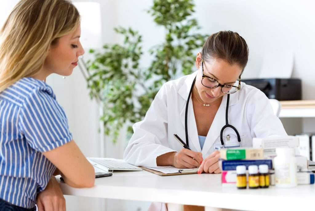 Female doctor explaining private medical insurance UK